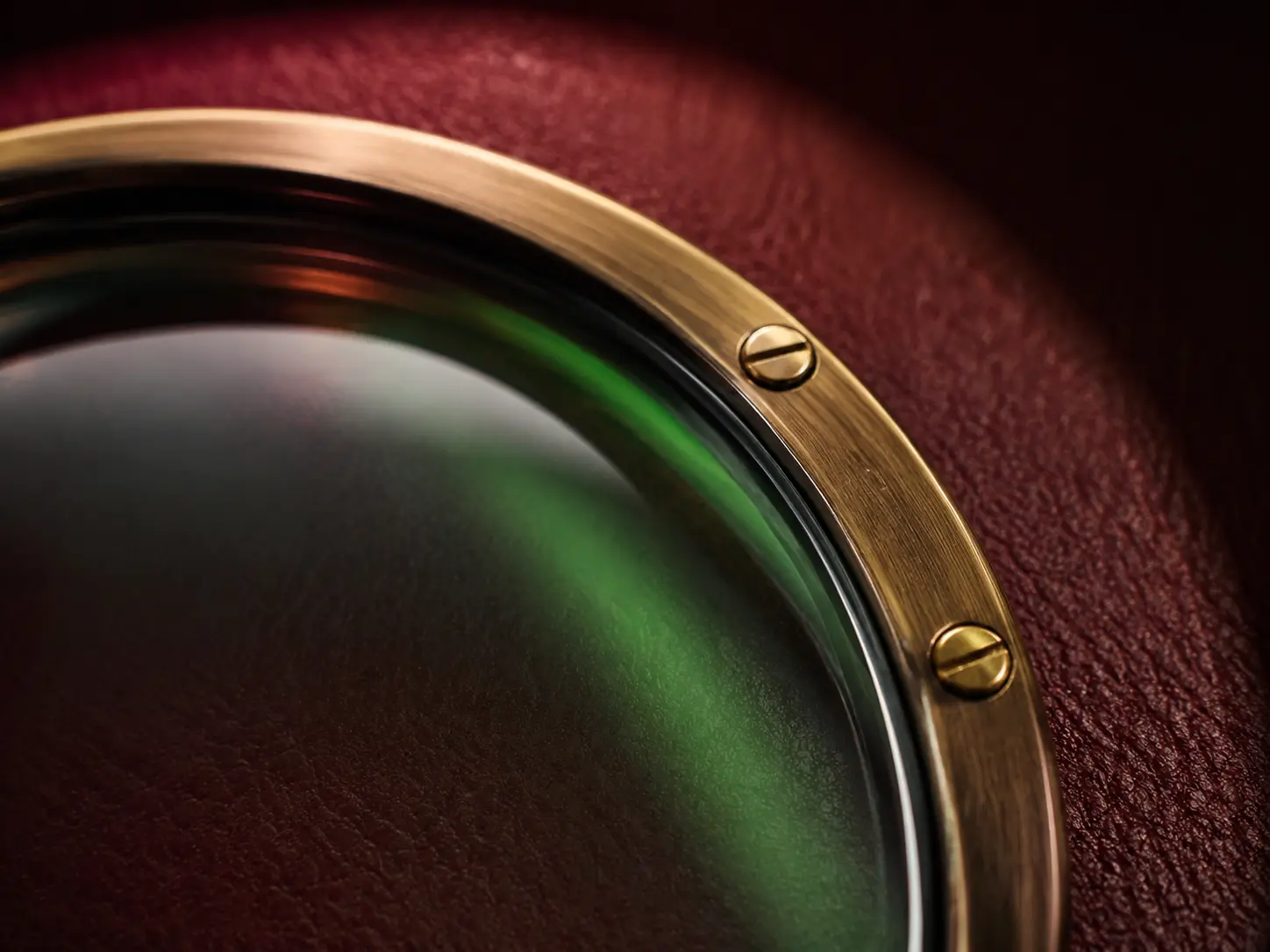 Macro view of a hand-finished brass monocle rim and optical coating